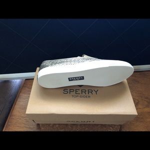 Sperry slip on sneakers.